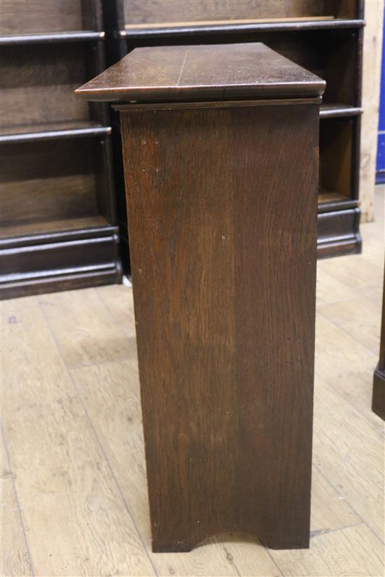 An early 20th century Arts & Crafts oak two door cupboard W.101cm